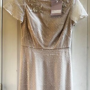 Cream beaded A-line gown by JS Collections.